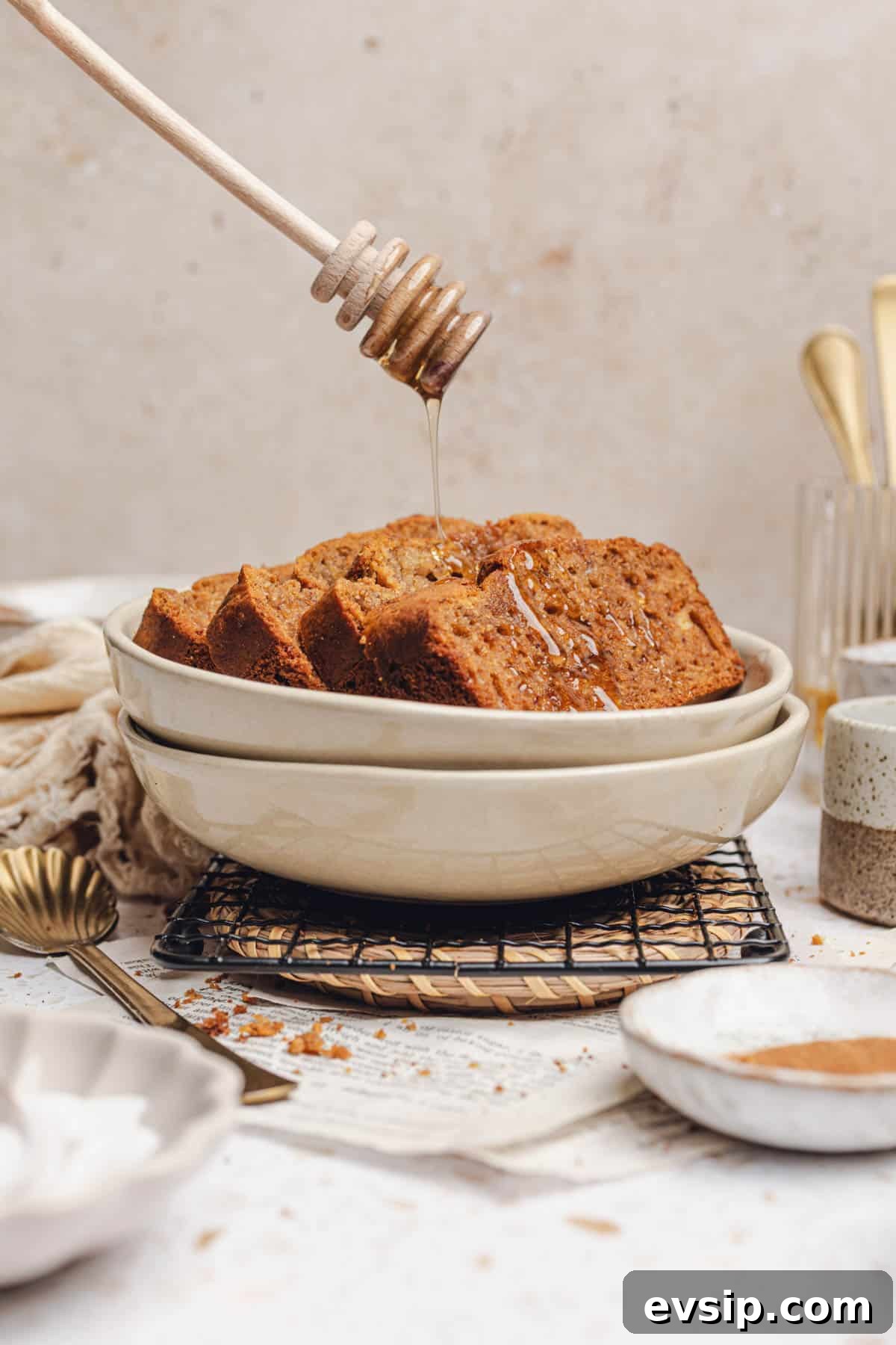 a bowl with slices of banana bread in it with honey drizzled on top 