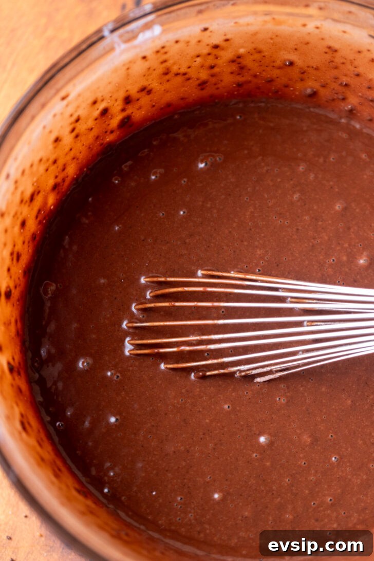 Decadent Snickers Dessert Cake Recipe for Chocolate Lovers 4 Chocolate cake batter in a bowl.