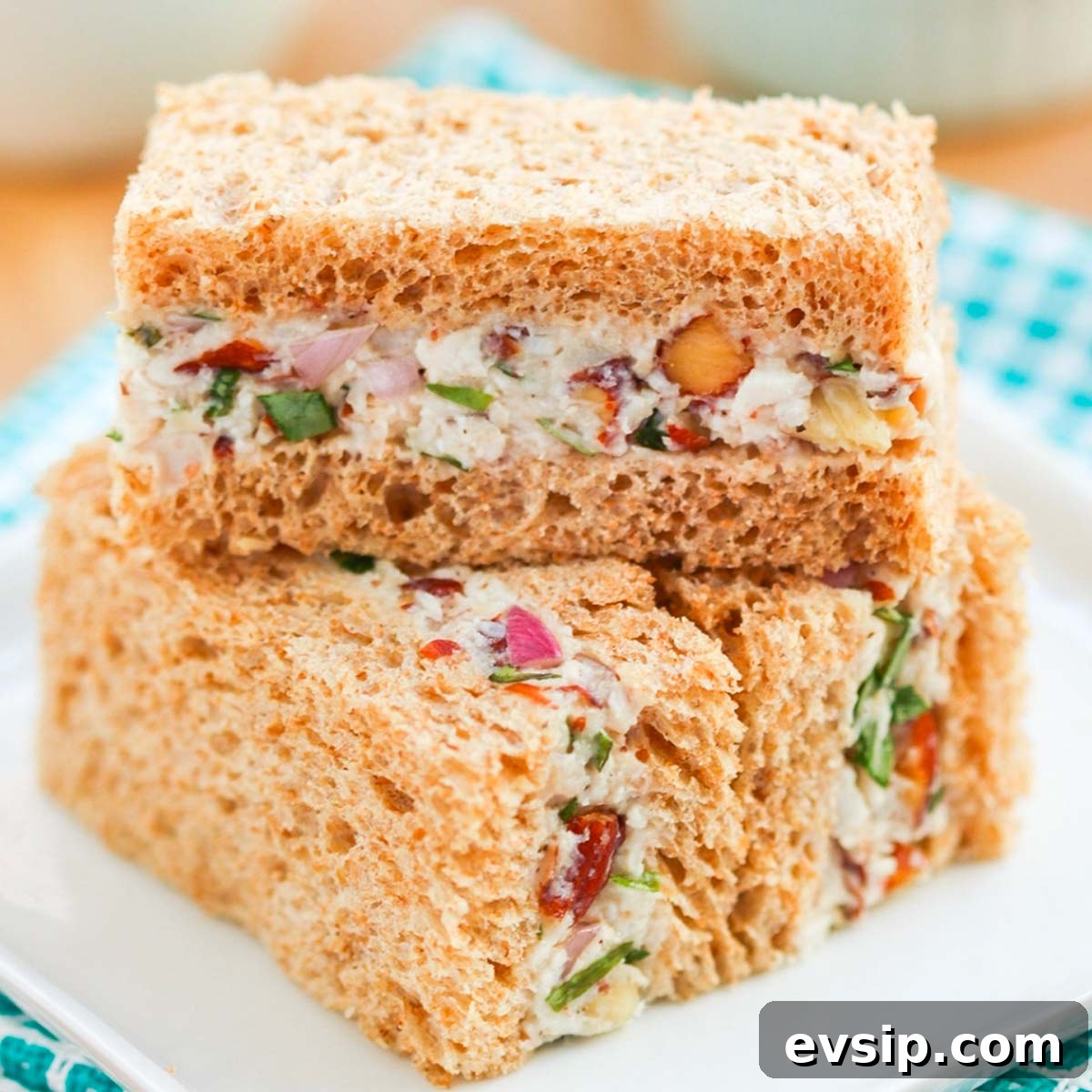 Turkey tea sandwiches stacked on a plate.