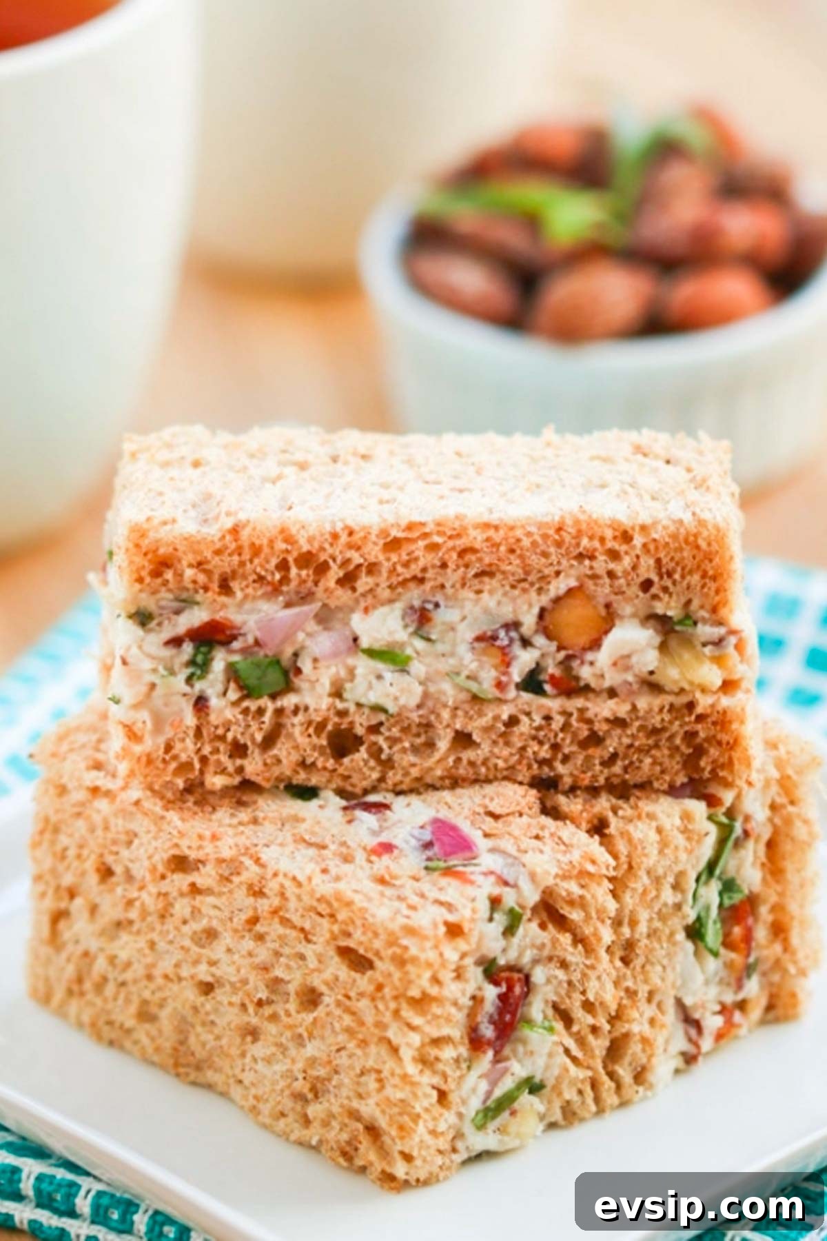 Turkey tea sandwiches, stacked on a plate.