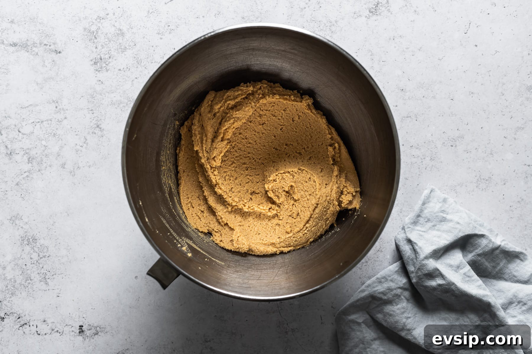 A process photo showing a mixing bowl of peanut butter cookie batter.