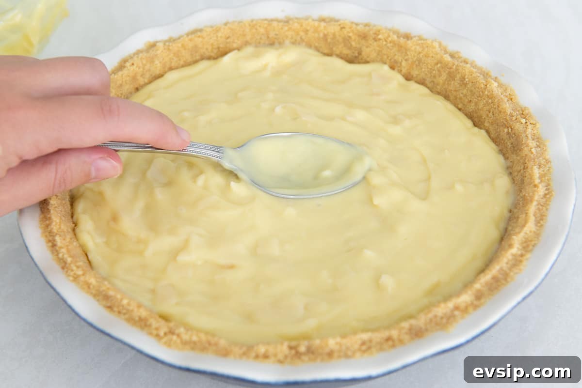 Classic Coconut Cream Pie Recipe: Silky, Homemade Dessert 12 Spreading the filling out into the vanilla wafer crust