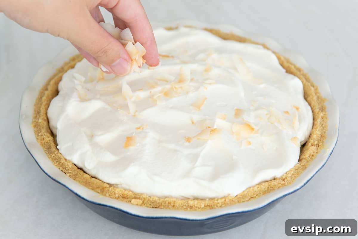 Classic Coconut Cream Pie Recipe: Silky, Homemade Dessert 15 Sprinkling toasted coconut flakes on top of the coconut cream pie