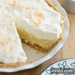 Classic Coconut Cream Pie Recipe: Silky, Homemade Dessert 17 Coconut Cream Pie in a Dish with Slice Taken Out