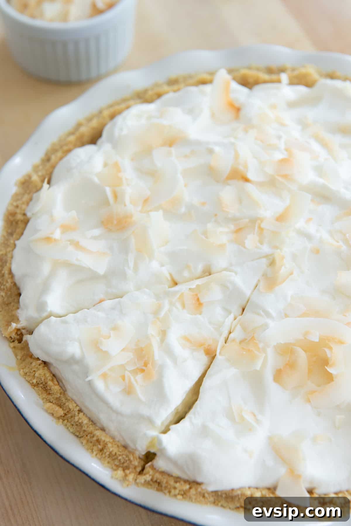 Classic Coconut Cream Pie Recipe: Silky, Homemade Dessert 3 A standard size coconut cream pie with a slice cut but not removed
