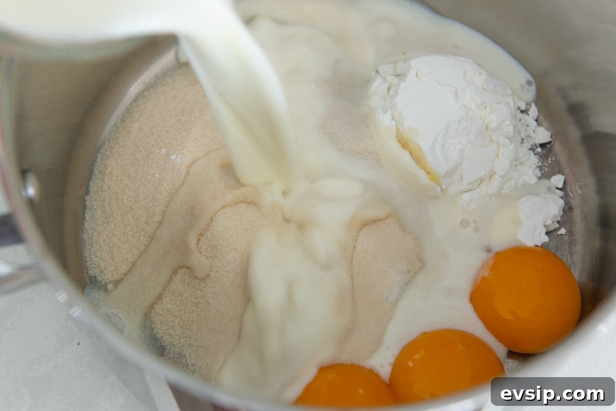 Classic Coconut Cream Pie Recipe: Silky, Homemade Dessert 5 Adding whole milk into the saucepan