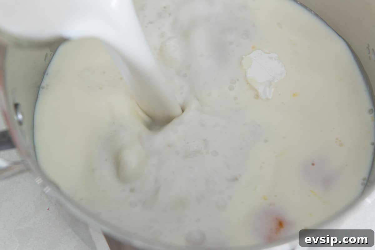 Classic Coconut Cream Pie Recipe: Silky, Homemade Dessert 6 Pouring canned coconut milk into the saucepan