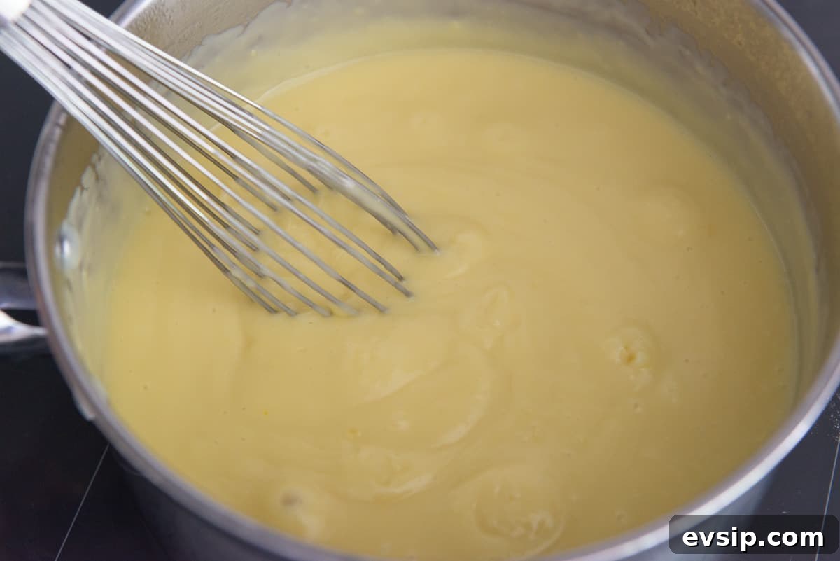 Classic Coconut Cream Pie Recipe: Silky, Homemade Dessert 8 Thickened coconut pudding bubbling in a saucepan
