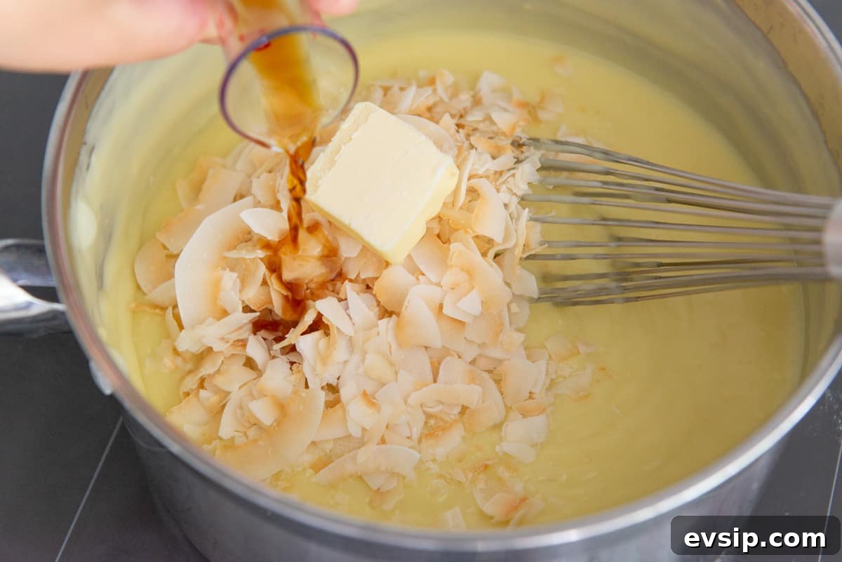 Classic Coconut Cream Pie Recipe: Silky, Homemade Dessert 9 Adding coconut flakes, butter, and vanilla extract to the coconut pudding filling
