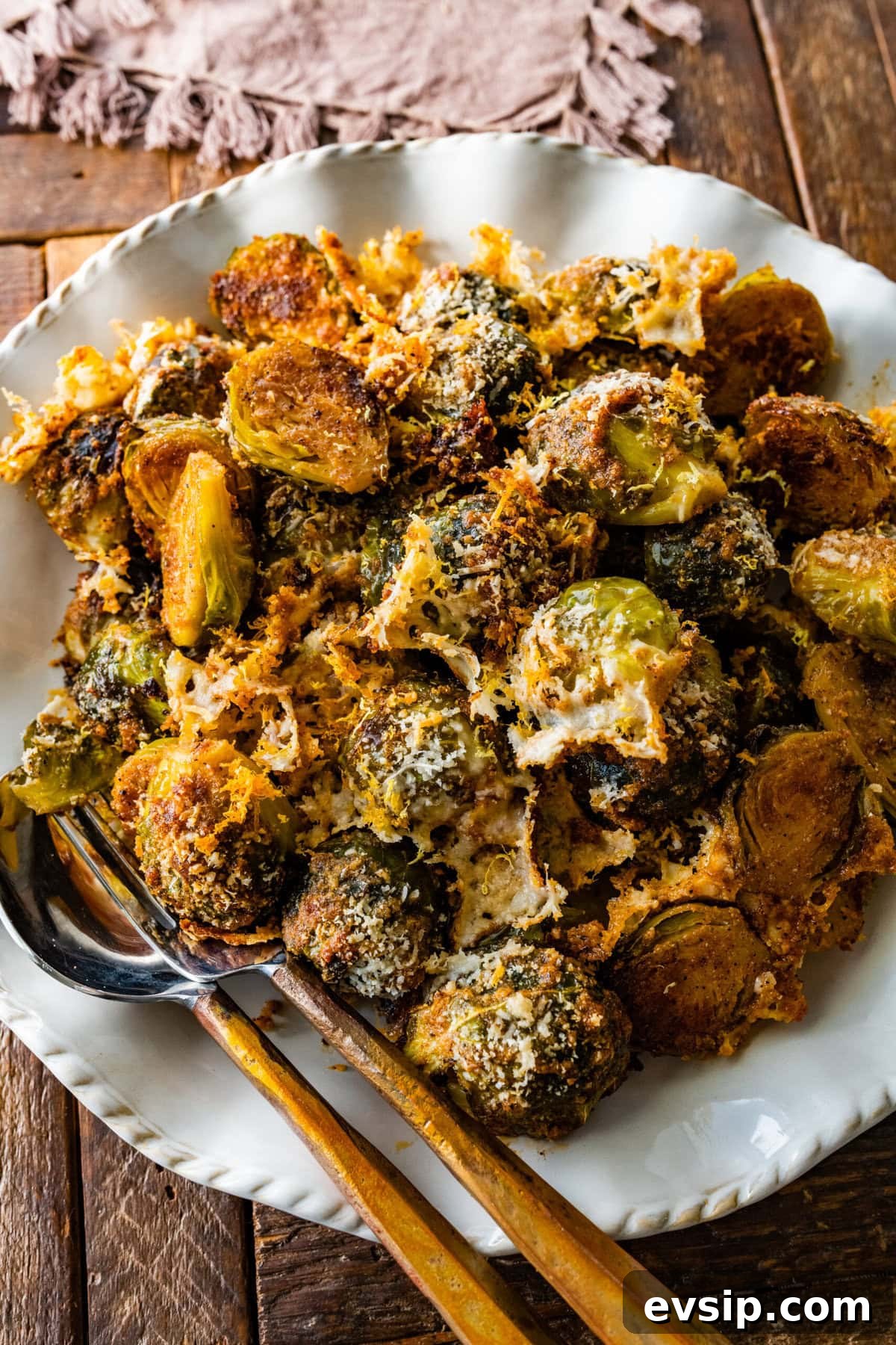 Parmesan Brussels Sprouts Recipe on a serving platter with serving utensils ready to serve.