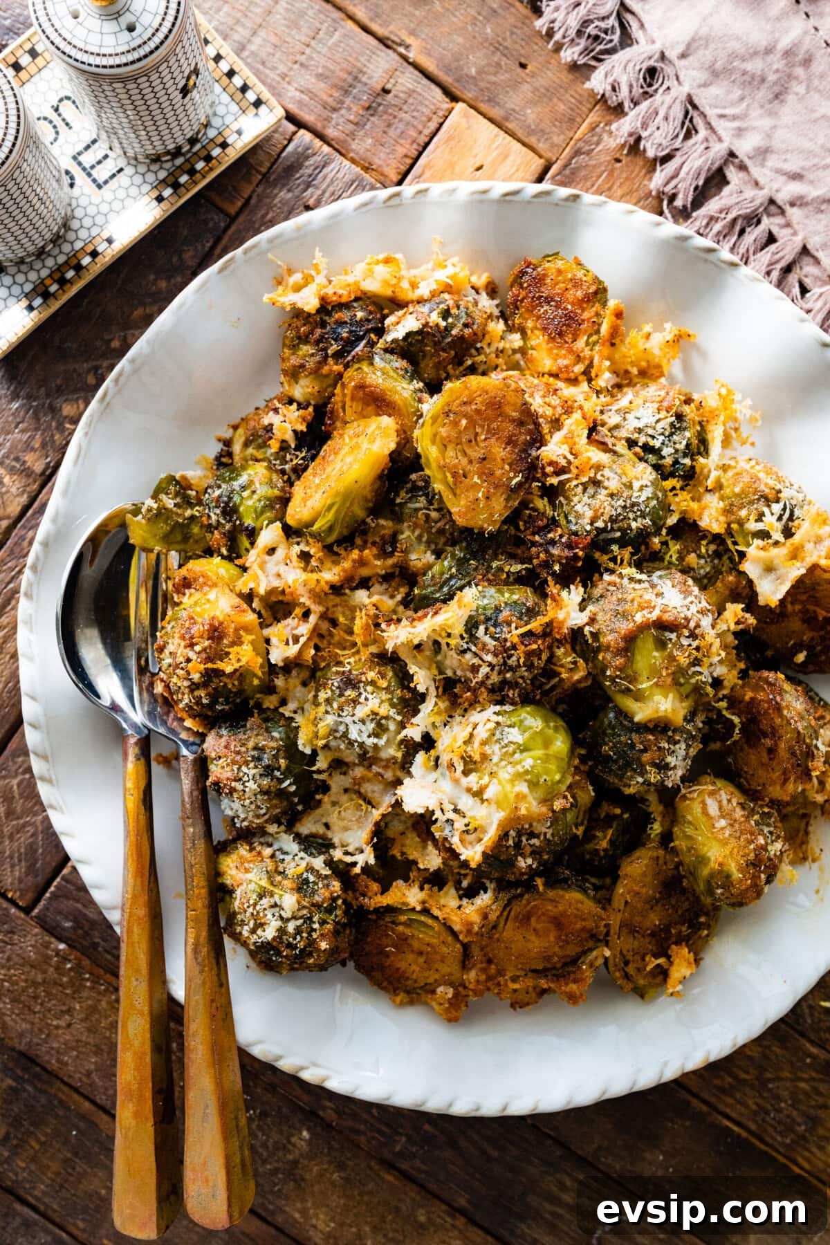 Parmesan Brussels Sprouts Recipe on a serving platter with serving utensils ready to serve.