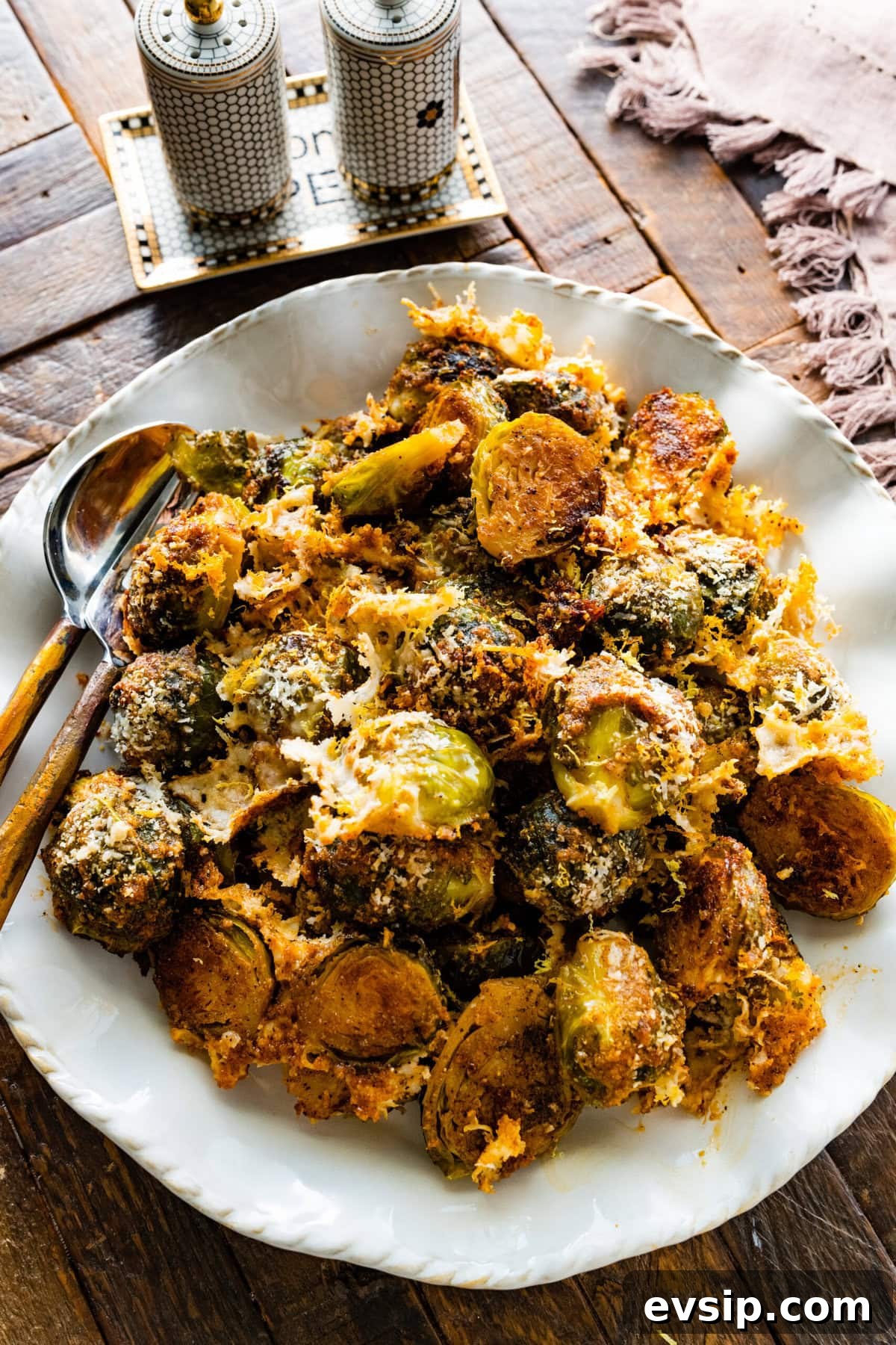 Parmesan Brussels Sprouts Recipe on a serving platter with serving utensils ready to serve.