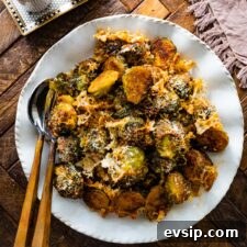 Parmesan Brussels Sprouts Recipe on a serving platter with serving utensils ready to serve.