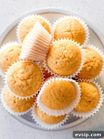 Mini honey muffins stacked on a plate.