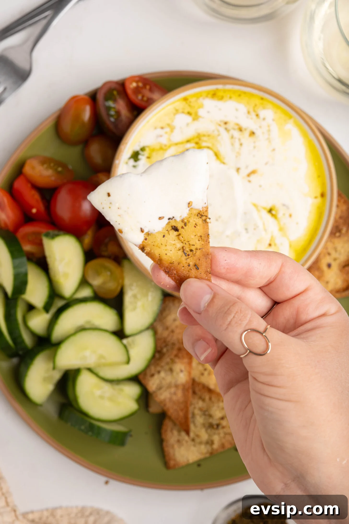 A pita chip dipped in whipped feta.