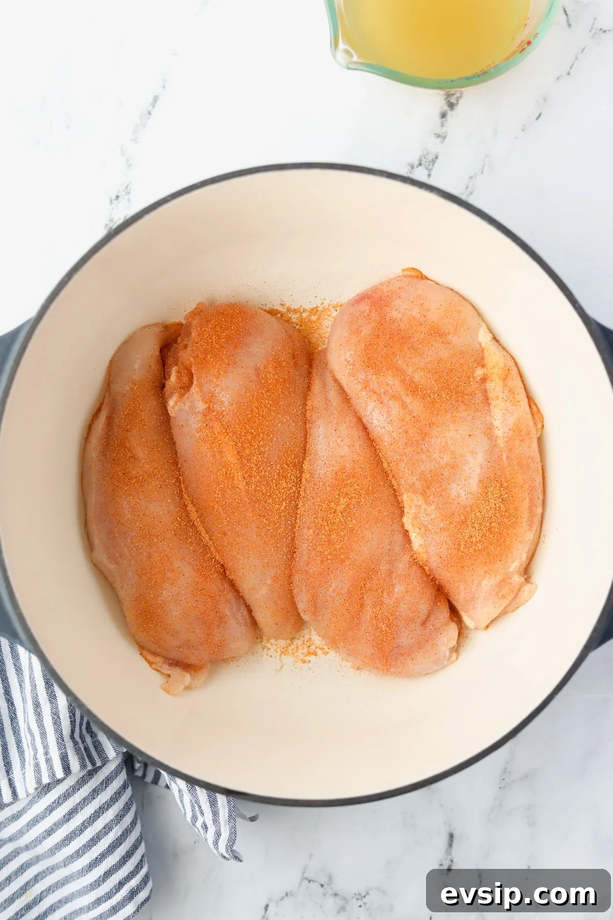 Juicy Shredded Chicken Made in a Dutch Oven 5 A Dutch Oven with four seasoned chicken breasts.