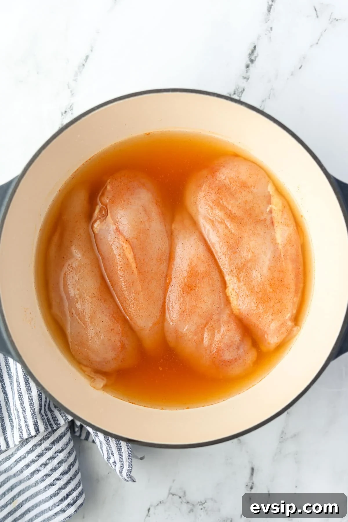 Juicy Shredded Chicken Made in a Dutch Oven 6 A Dutch Oven with broth-covered chicken breasts.