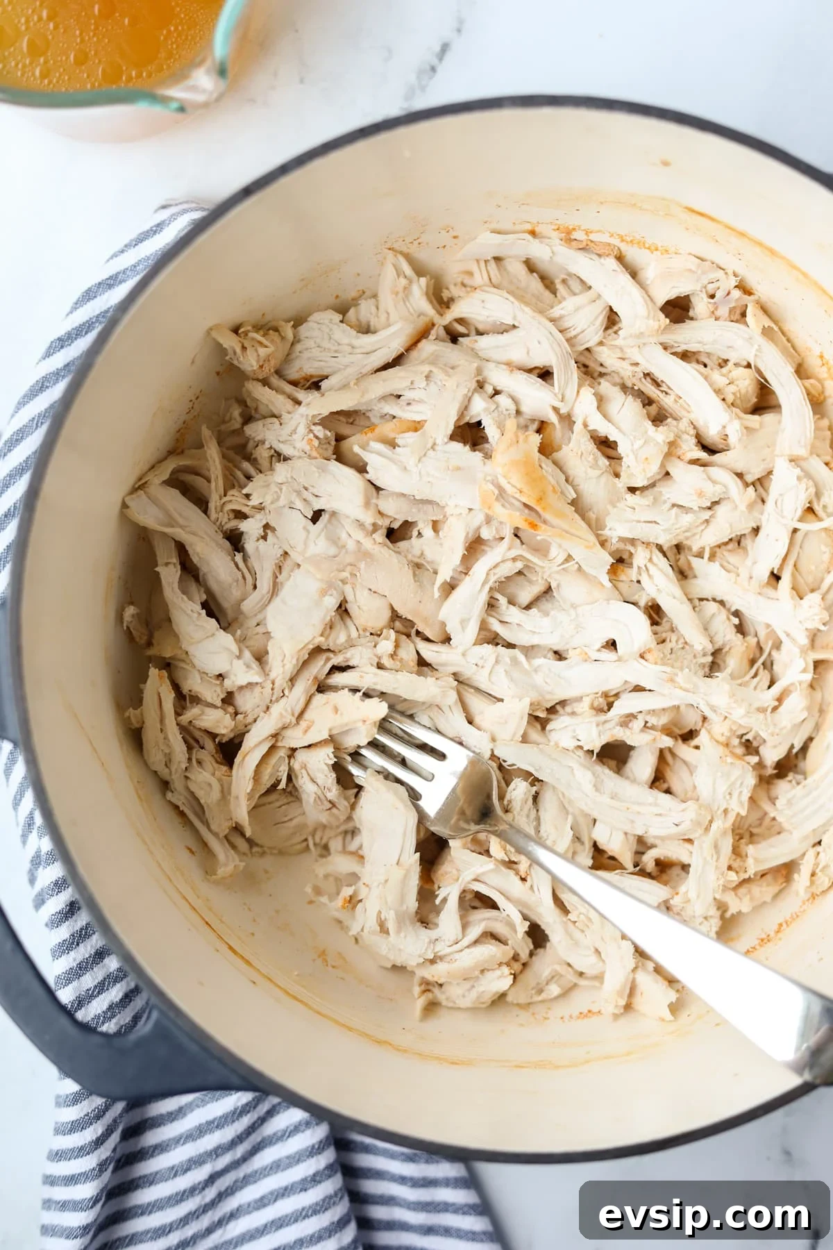Juicy Shredded Chicken Made in a Dutch Oven 10 A large pot filled with shredded chicken.