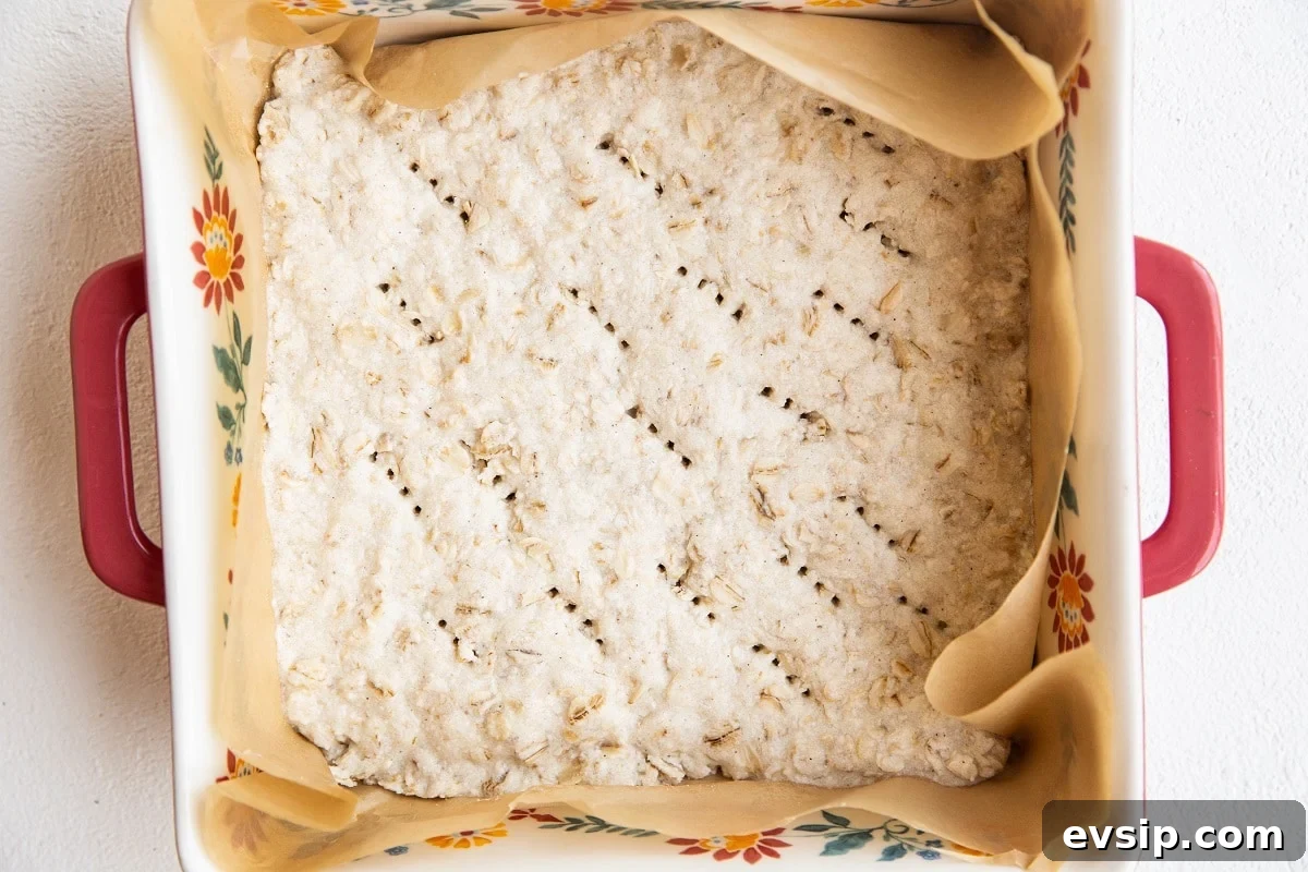Gluten-Free Vegan Blackberry Pie Bars — 5 Ingredients 6 Finished oatmeal bar crust in a baking dish.