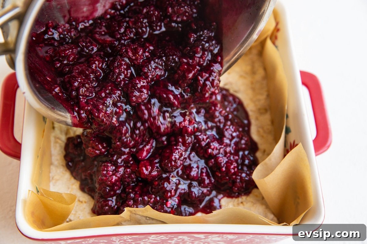 Gluten-Free Vegan Blackberry Pie Bars — 5 Ingredients 9 Pouring blackberry jam filling over the baked crust