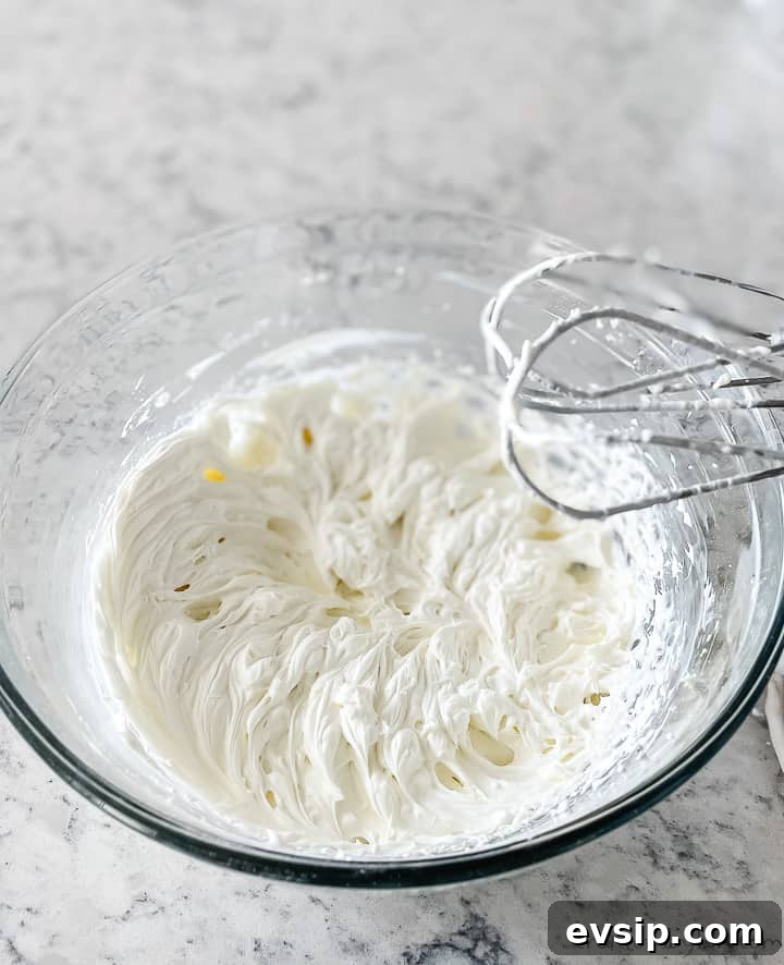 bowl of whipped cream with beaters
