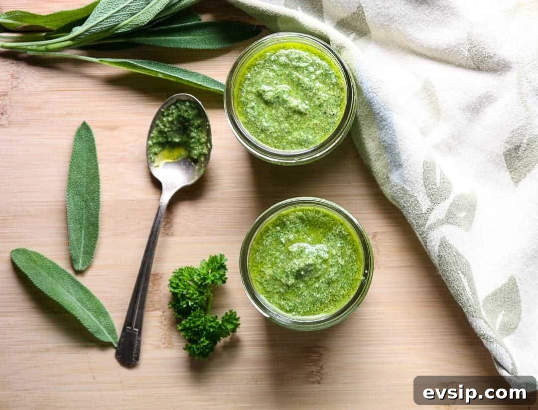 Two jars of pesto on a wooden cutting board