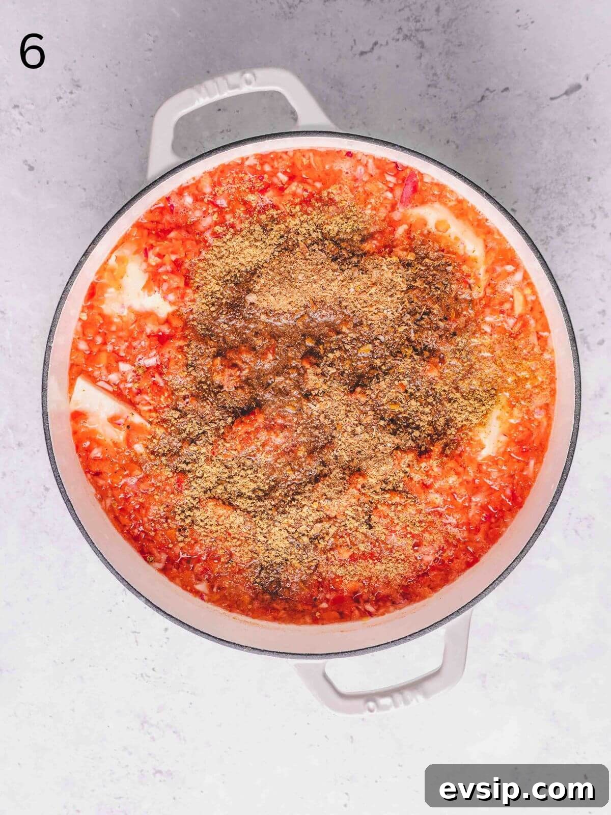 Pepper mix, crayfish and palm oil added into the pot with yam.