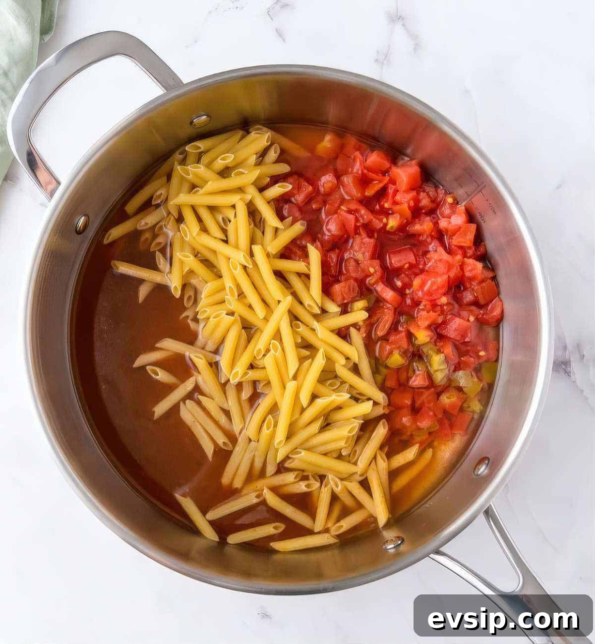 30-Minute One-Pot Chicken Enchilada Pasta Recipe 4 Pasta and diced tomatoes added to a skillet with enchilada sauce and broth to start chicken enchilada pasta