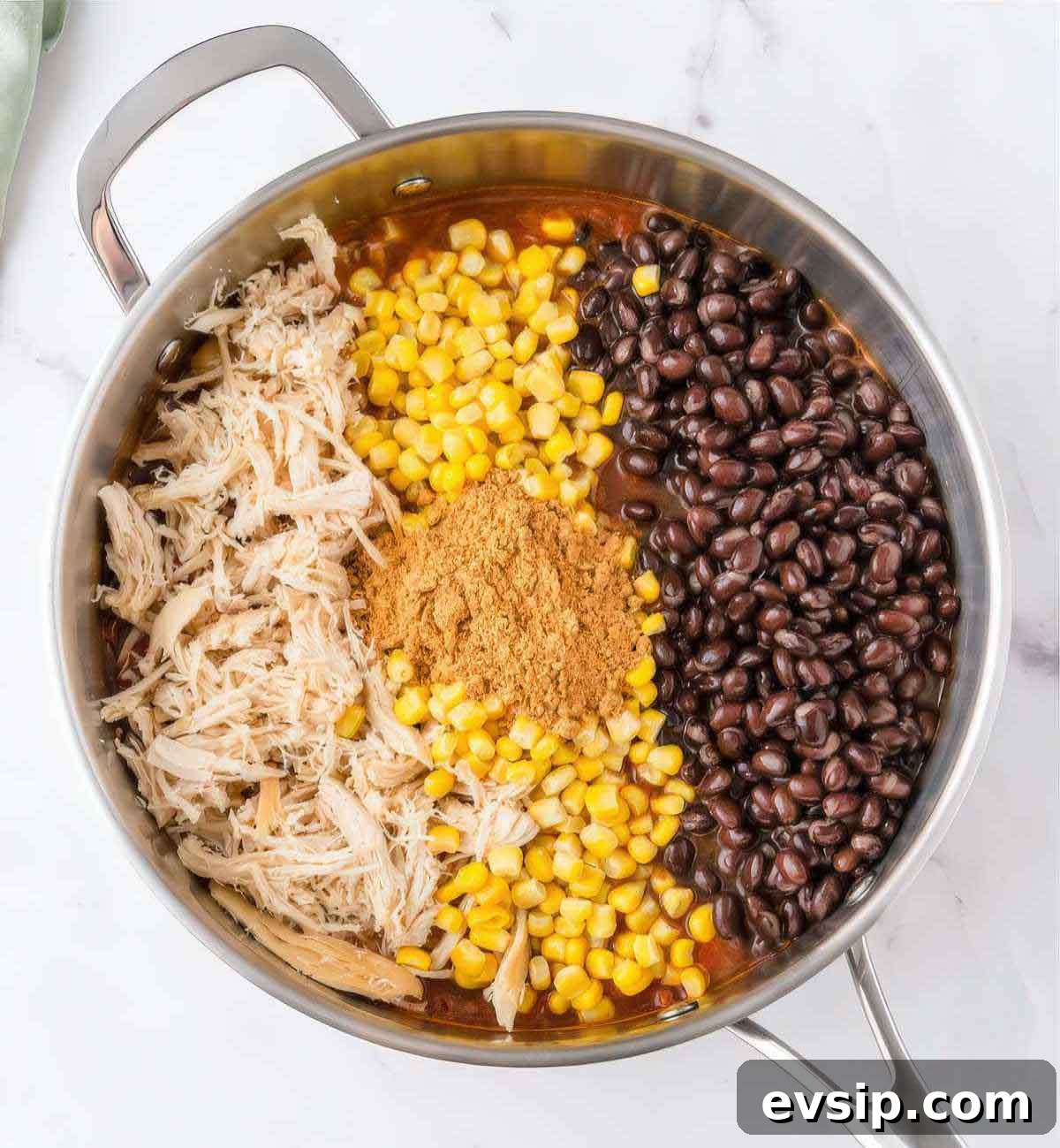 30-Minute One-Pot Chicken Enchilada Pasta Recipe 5 Shredded chicken, black beans, corn and taco seasoning added to skillet for chicken enchilada pasta