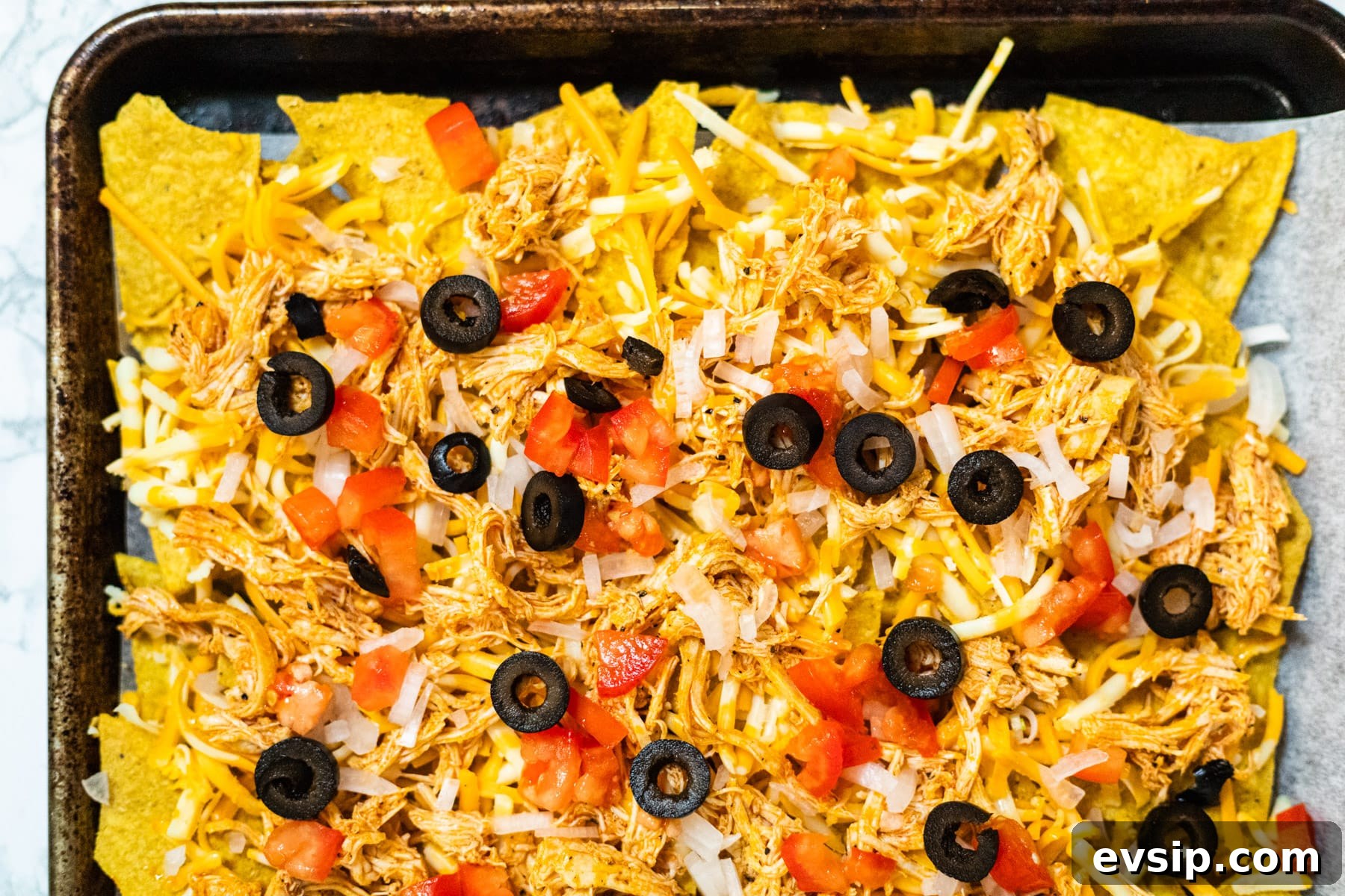Buffalo Chicken Nachos Recipe for Crispy, Spicy Game Day Nachos 6 Assembled nachos ready to bake