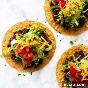A top down view of three black bean tostadas.