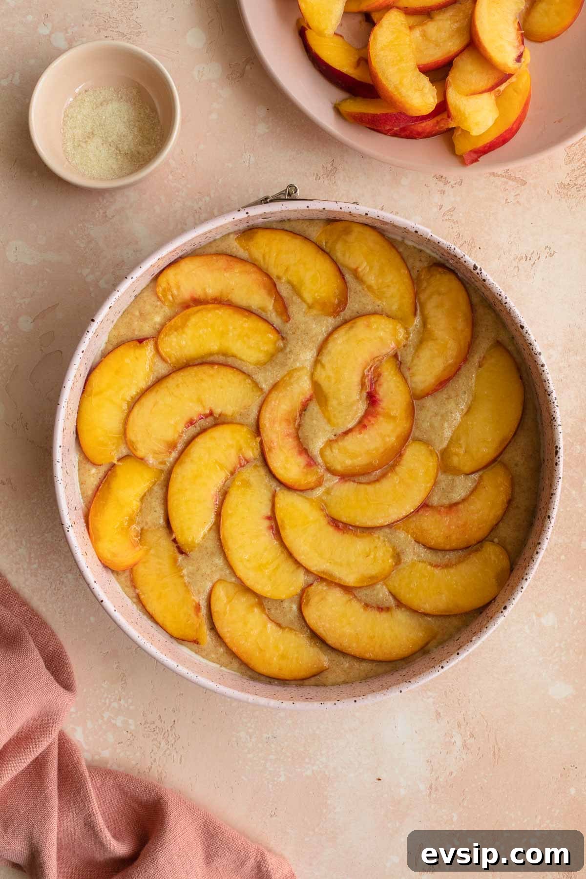 Peach Ricotta Cake Recipe — Moist Summer Fruit Dessert 7 Cake batter in a springform pan topped with peach slices.