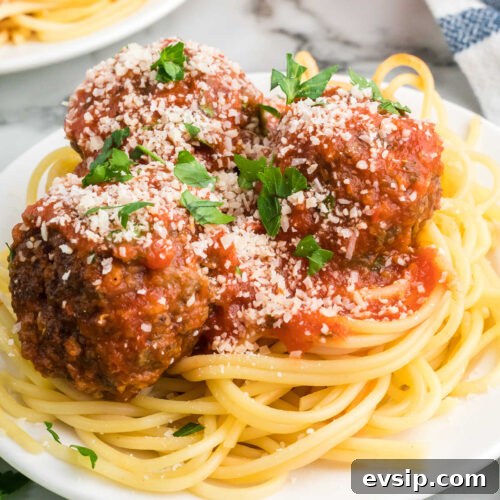 Top Blackstone Griddle Appetizers for Parties and Game Day 13 Spaghetti and meatballs on a white plate.