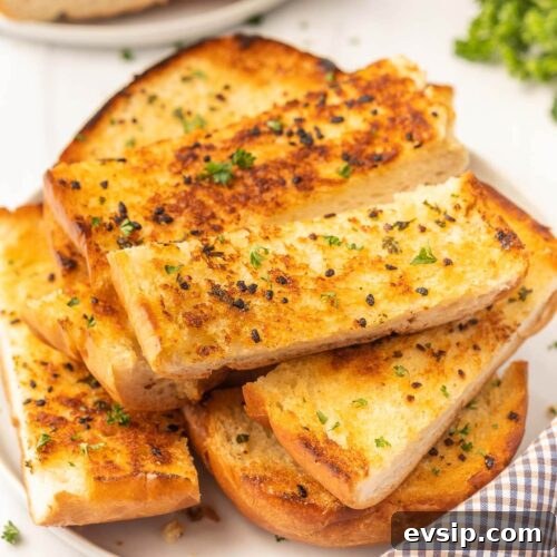 Top Blackstone Griddle Appetizers for Parties and Game Day 14 Grilled garlic bread slices on a white plate.