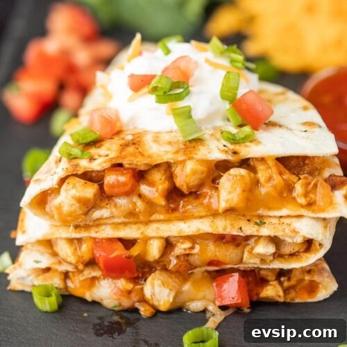 Top Blackstone Griddle Appetizers for Parties and Game Day 16 Chicken quesadillas with sour cream and cheese.