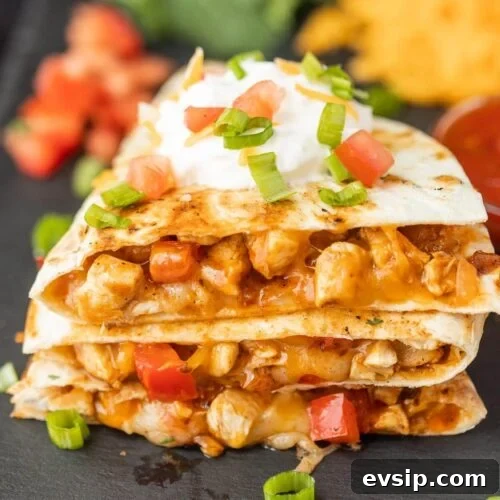 Top Blackstone Griddle Appetizers for Parties and Game Day 20 Chicken quesadillas with sour cream and cheese.