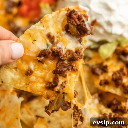 Top Blackstone Griddle Appetizers for Parties and Game Day 6 Taco nachos with beef, cheese, and sour cream.
