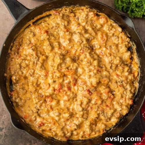Top Blackstone Griddle Appetizers for Parties and Game Day 8 A skillet filled with cheesy chicken in a red pot.