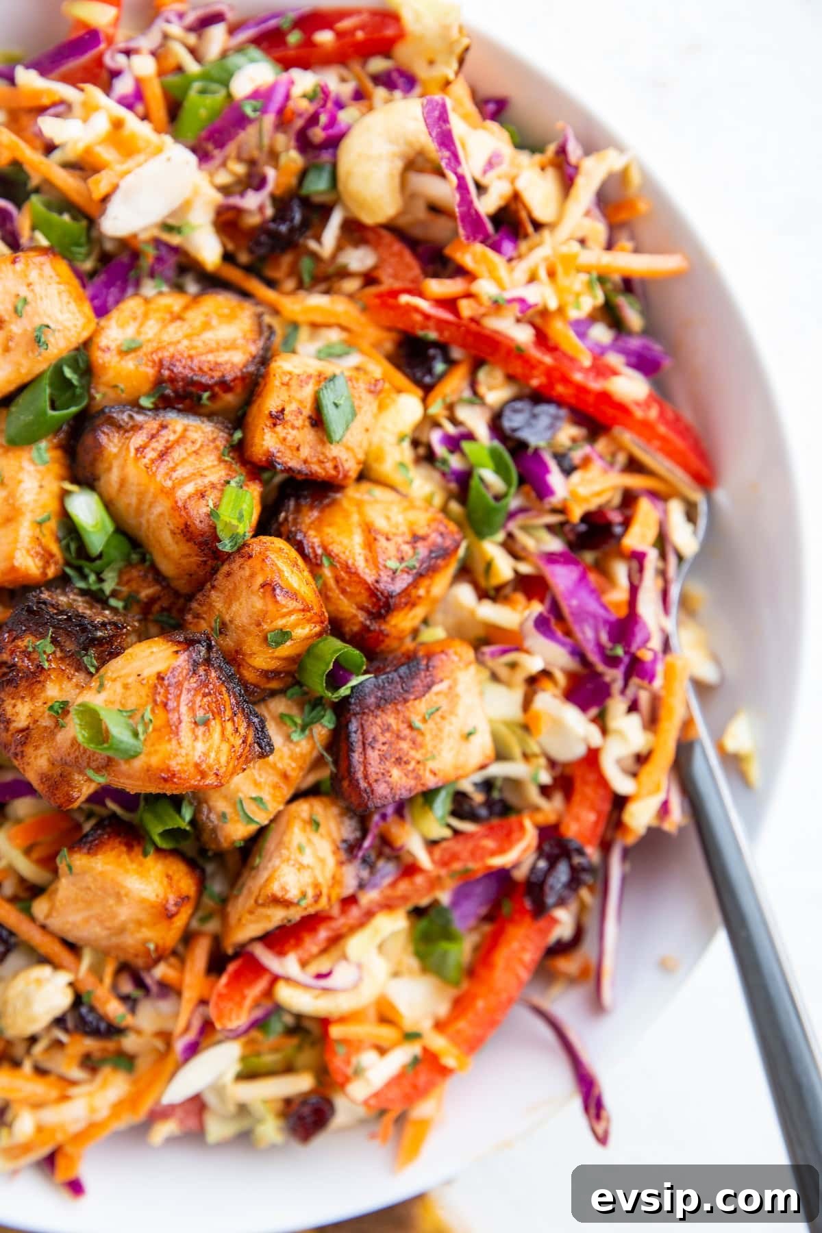 Crispy salmon chunks on top of a salad to make a full meal.
