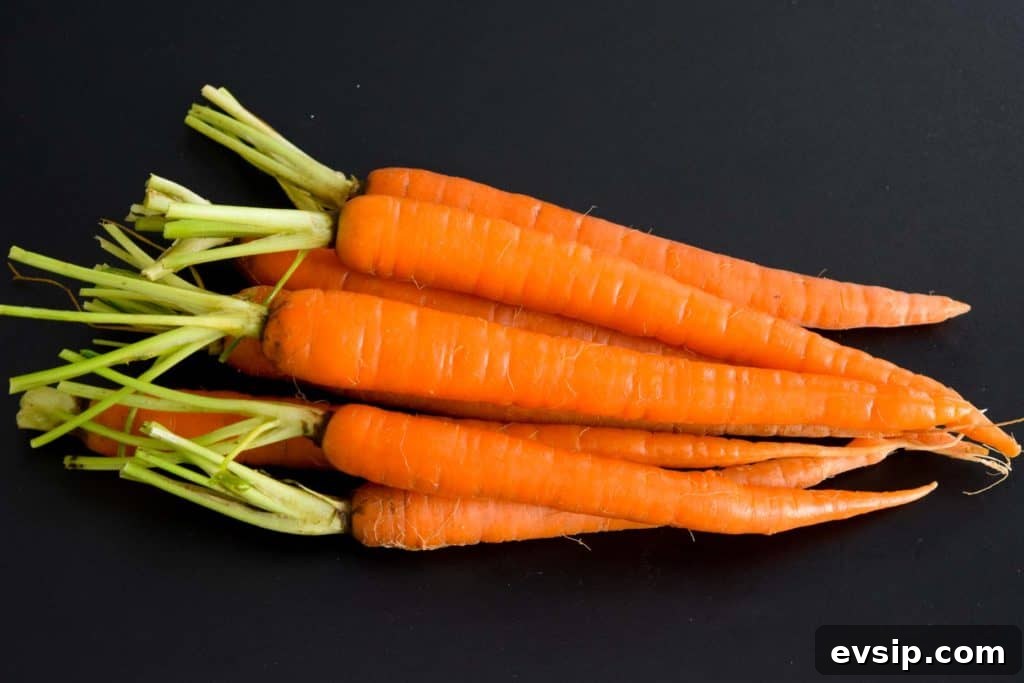 pile of carrots on black background 