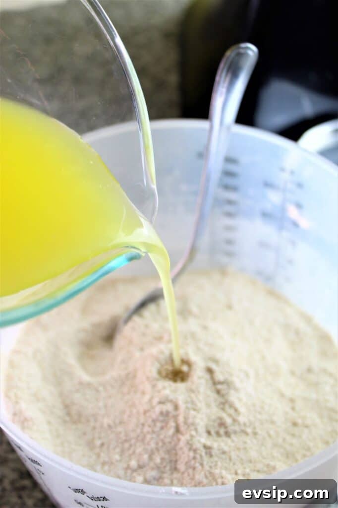 pouring melted butter into brown sugar mixture