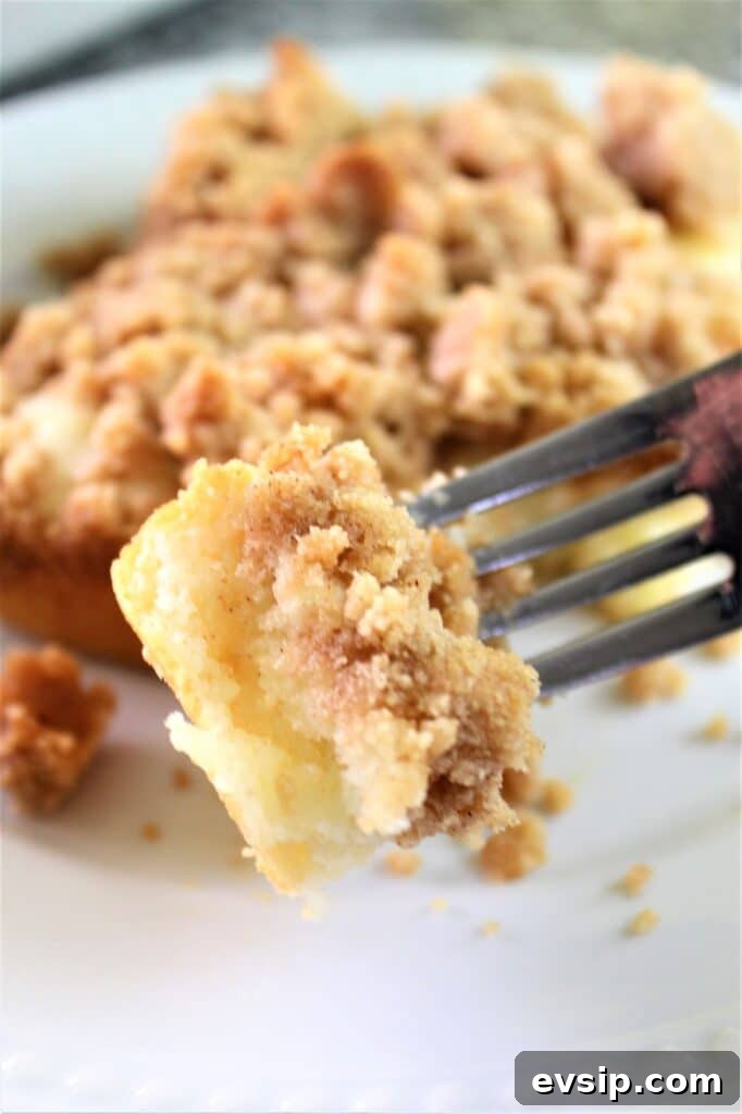 picking up a piece of crumb cake on fork