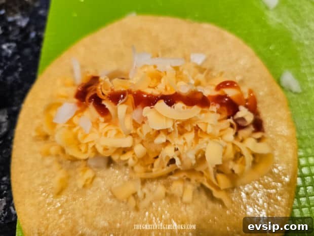 Air Fryer Cheese Enchiladas - The Grateful Girl Cooks! Each tortilla is filled with cheese, onions and sauce before rolling.