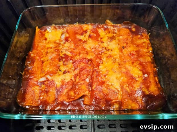 Air Fryer Cheese Enchiladas - The Grateful Girl Cooks! Sauce is bubbly and cheese is melted on the enchiladas after cooking.
