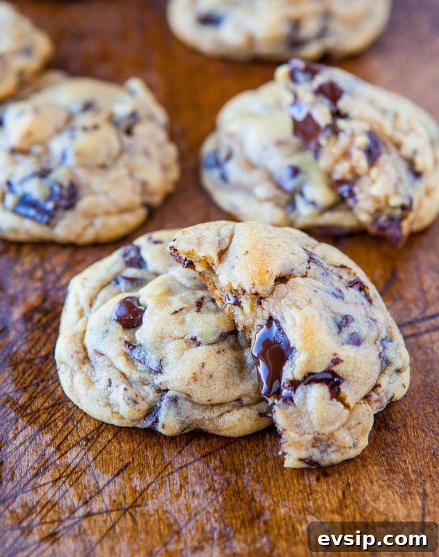 Chewy Chocolate Chip & Peanut Butter Chip Cookie Recipe 12 Chocolate Chip and Chunk Cookies on a wooden table.