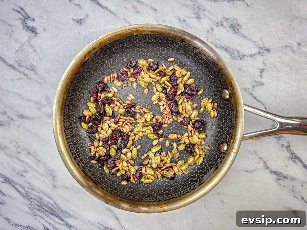 Stir in seeds, pumpkin spice, salt, and cranberries.