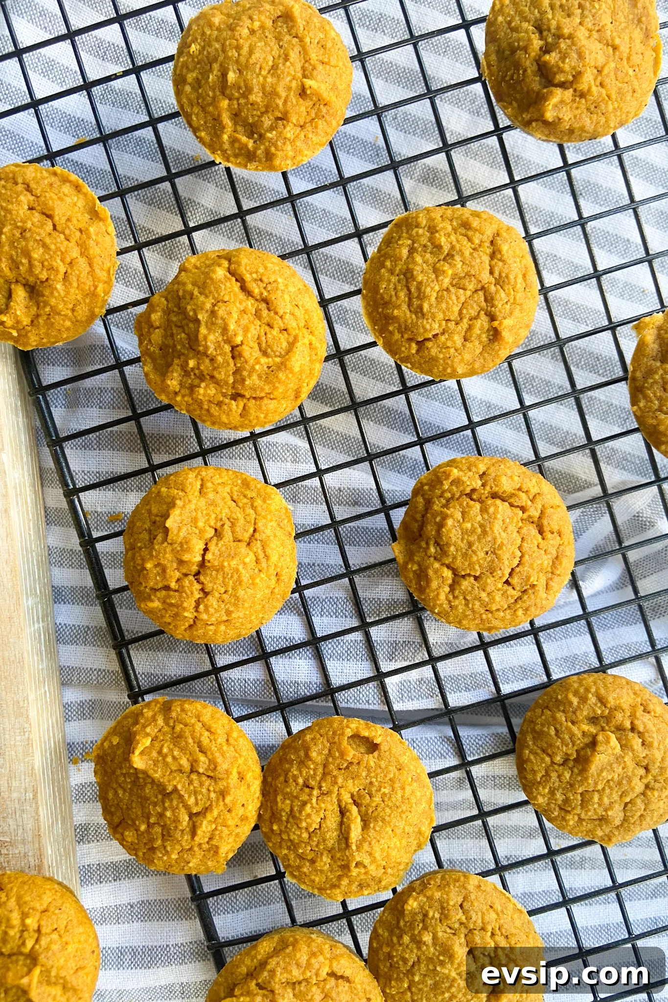 15 Kid-Friendly Pumpkin Recipes for Fall 3 Pumpkin muffins cooling on a cooling rack