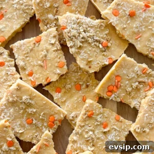 15 Kid-Friendly Pumpkin Recipes for Fall 24 Pumpkin yogurt bark on a wooden board.