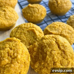 15 Kid-Friendly Pumpkin Recipes for Fall 4 Pumpkin muffins served on a wooden cutting board and on a cooling rack