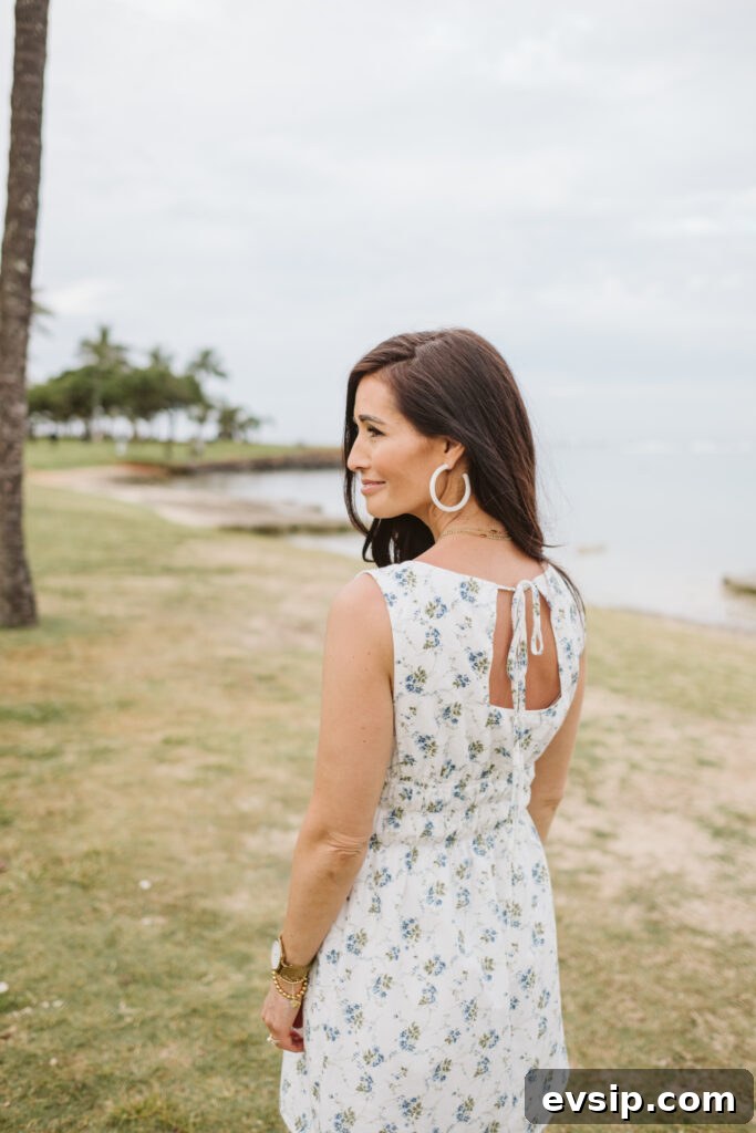 Tor showing the ppen back of her blue and white floral dress from The Fraîche x PRIV Summer Collection